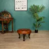 Round Chesterfield footstool in Havana full-grain leather in living room setting